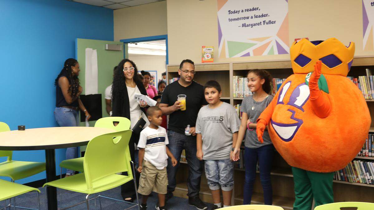 Parents, teachers and students greet Orange Bowl mascot Obie at the opening of the updated media center at Miami Gardens Elementary, the Miami-Dade County winning school of the Orange Bowl Media Center Makeover Project.
