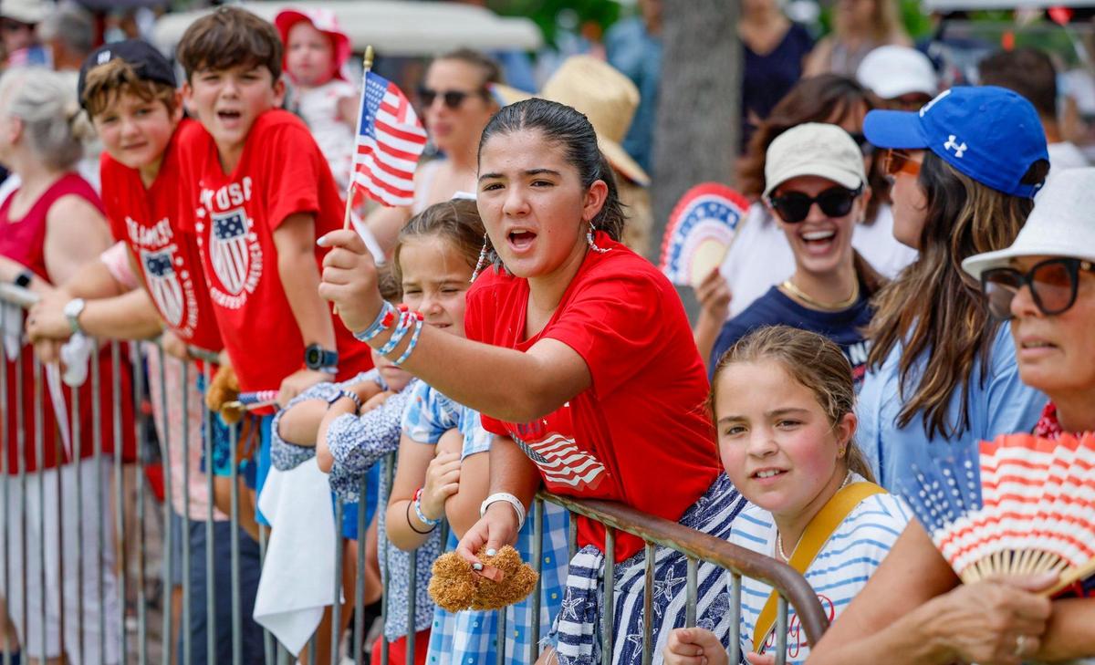 Claudia Capote, 12, joins residents, family and friends along the route of the 66th Annual Key Biscayne Fourth of July Parade on Key Biscayne, Florida on Friday, July 4, 2025.