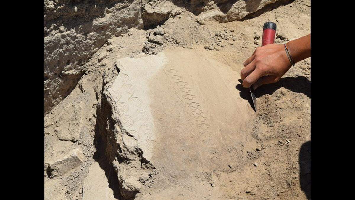 Several symbolic artifacts were found around the armor, archaeologists said.