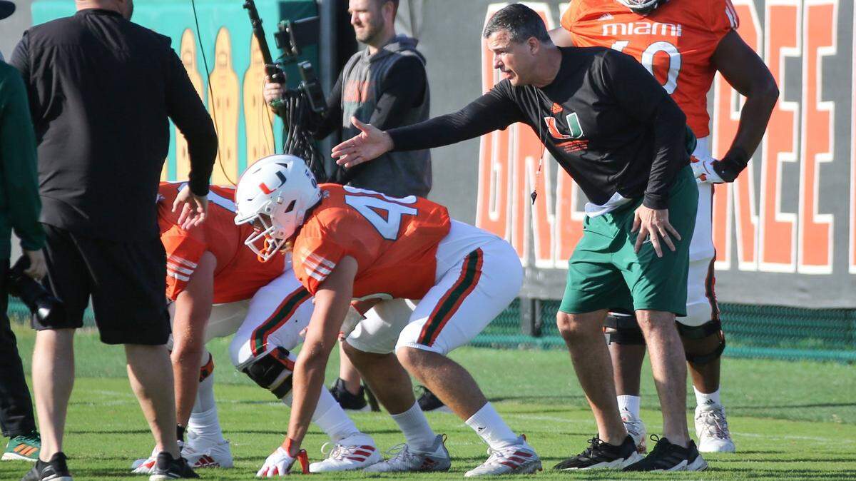 Miami Hurricanes head coach Mario Cristobal works with the offensive line during practice at the University of Miamis Greentree Practice Field in Coral Gables on Tuesday, March 22, 2022.