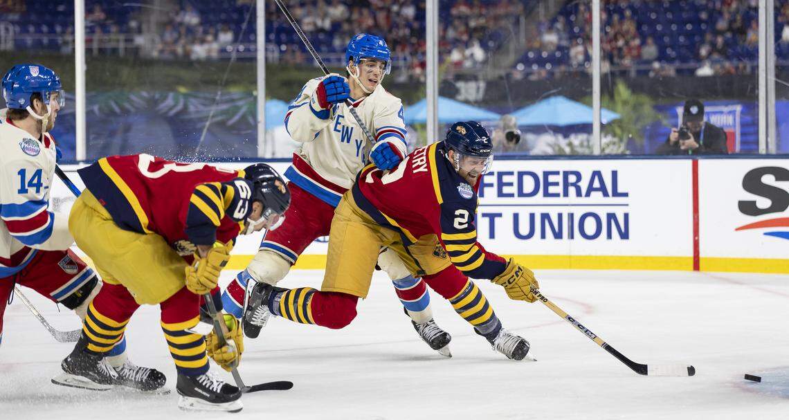 Florida Panthers defenseman Jeff Petry (2) shoots the puck as New York Rangers defenseman Braden Schneider (4) defends in the third period of their Winter Classic outdoor hockey game at loanDepot park on Friday, Jan. 2, 2026, in Miami, Fla.