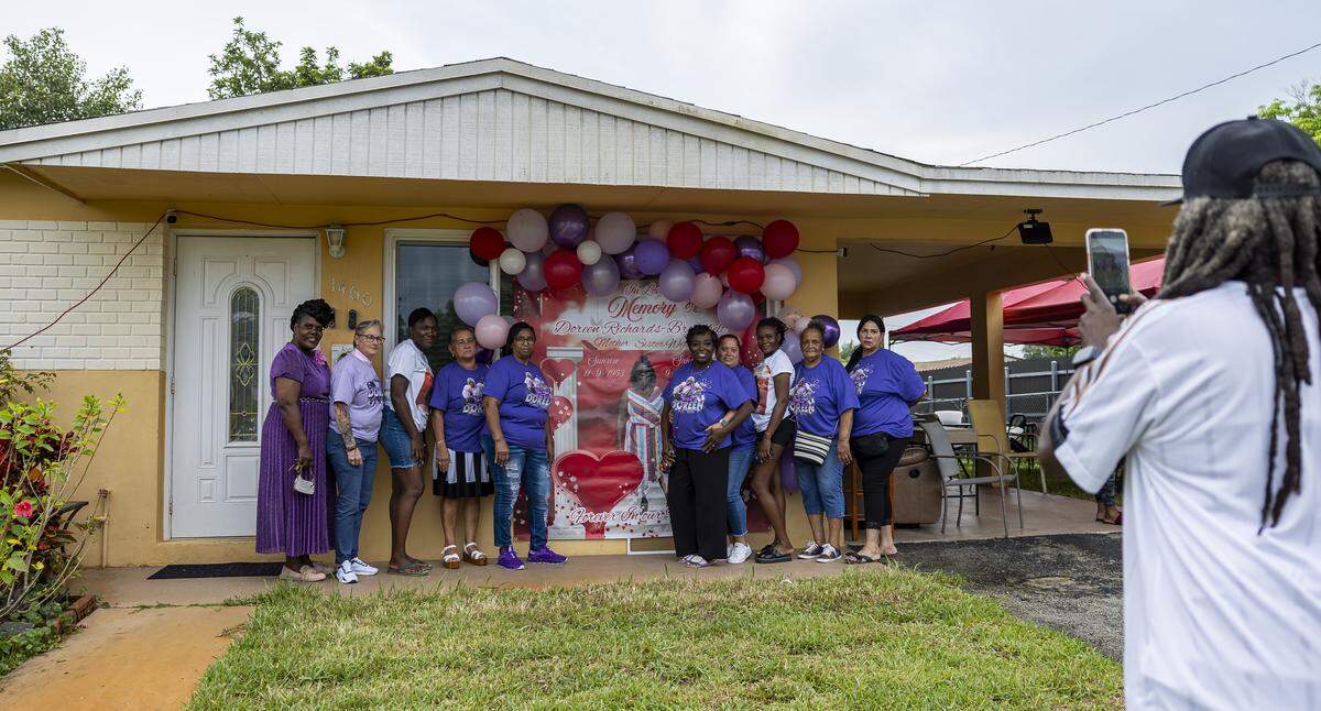 Family, friends, and coworkers of the late Doreen Richards Broadbelt gather at her home for a vigil on Tuesday, Sept. 9, 2025, in Miami Gardens, Fla. Broadbelt, 71, was walking to her job at Walmart when a dog attacked and fatally mauled her near her home on Labor Day, police said.