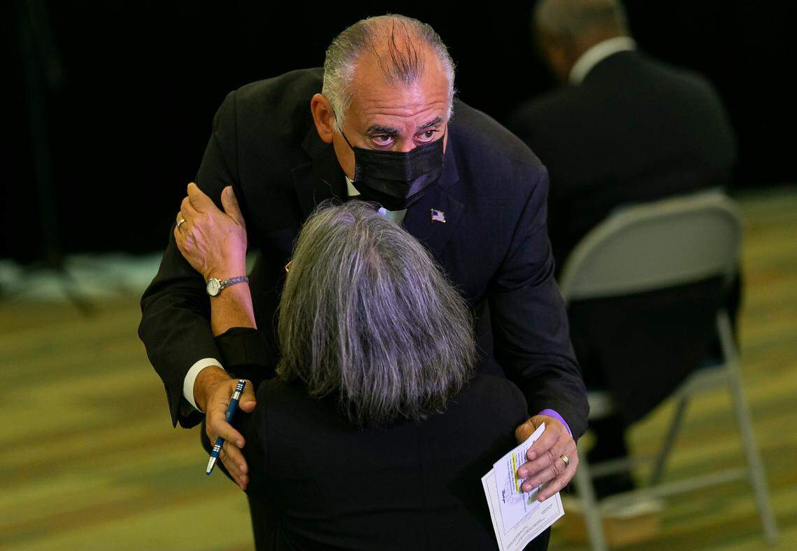 Commissioners Esteban L. Bovo Jr. and Daniella Levine Cava hug before the start of a farewell event for term-limited commissioners and Mayor Carlos Gimenez at Port Miami in Miami, Florida, on Friday, November 6, 2020.