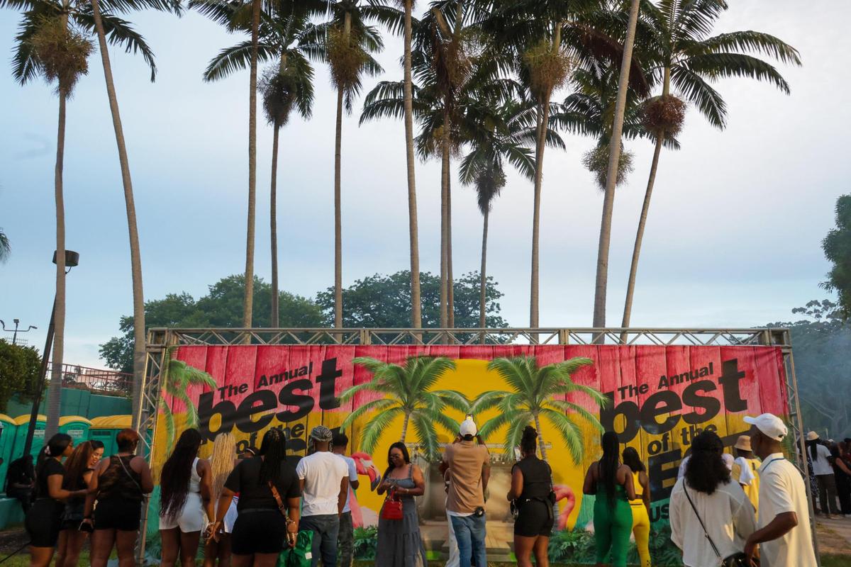 Concertgoers take pictures by a sign during the 19th annual Best of the Best International Music Festival at Bayfront Park in downtown Miami, Sunday, May 25, 2025.