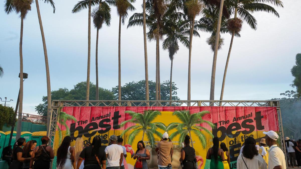 Concertgoers take pictures by a sign during the 19th annual Best of the Best International Music Festival at Bayfront Park in downtown Miami on Sunday, May 25, 2025.