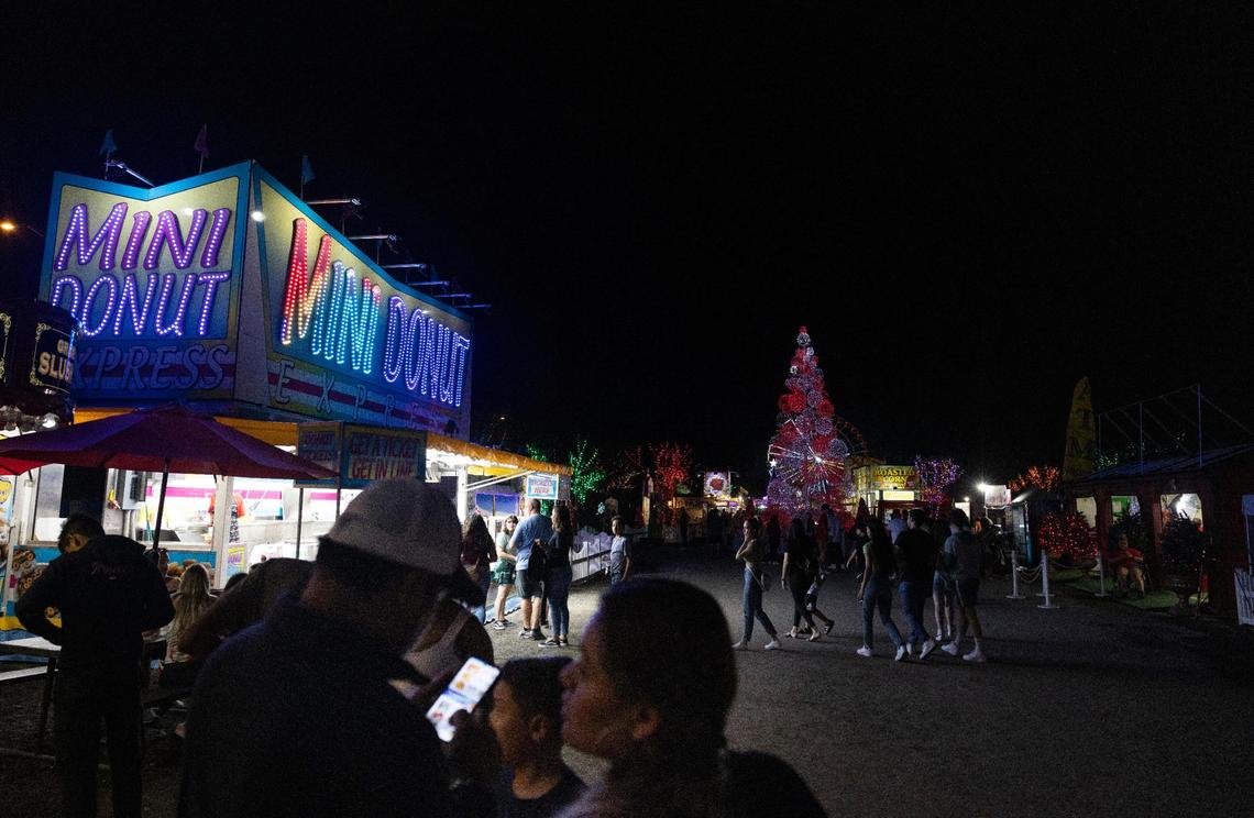 People walk into Santa’s Enchanted Forest on opening night.