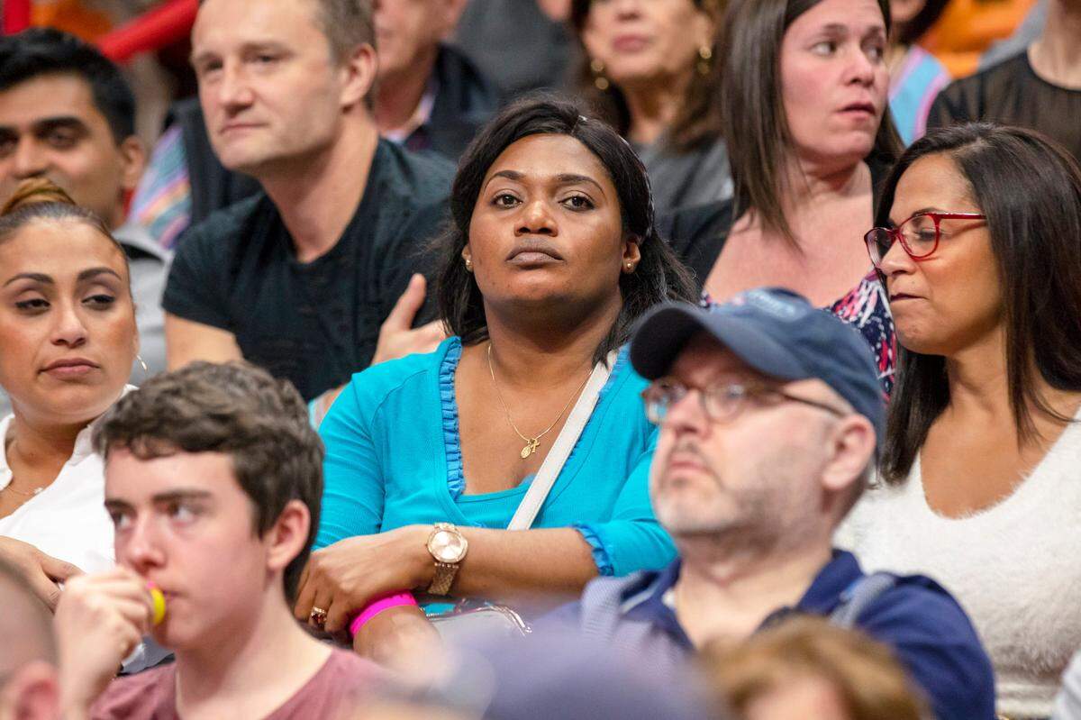 Miami Heat big man Chris Silva’s mother, Carine Minkoue Obame, center, during a game against the Philadelphia 76ers at AmericanAirlines Arena on Saturday, December 28, 2019.