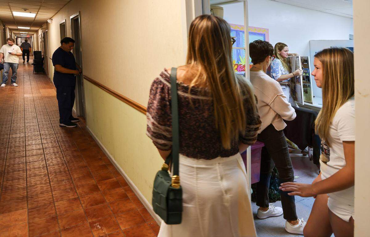 Resident artist Shelby Slayden, second from the left, explains her art practice as ICA cohorts visited her Tunnel Projects studio, a multifaceted art space dedicated to supporting local artists on Saturday, April 11, 2026, in Little Havana, Miami, Florida.