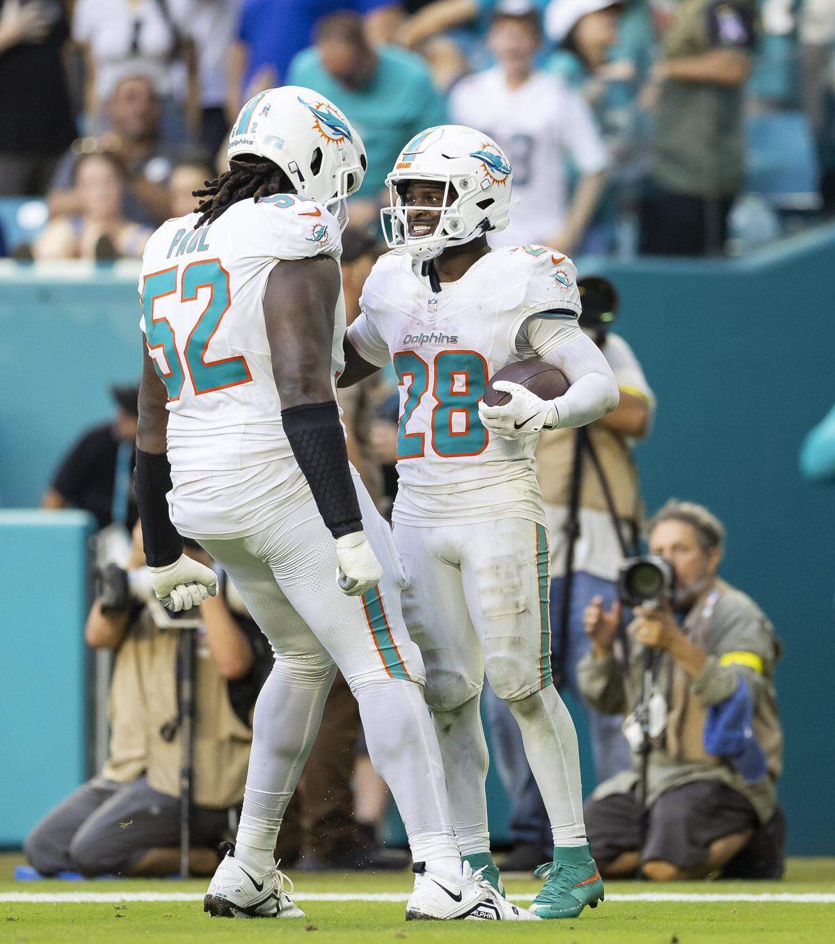 Miami Dolphins running back De'Von Achane (28) celebrates with offensive tackle Patrick Paul (52) after scoring against the Buffalo Bills in the second half of their NFL game at Hard Rock Stadium on Sunday, Nov. 9, 2025, in Miami Gardens, Fla.