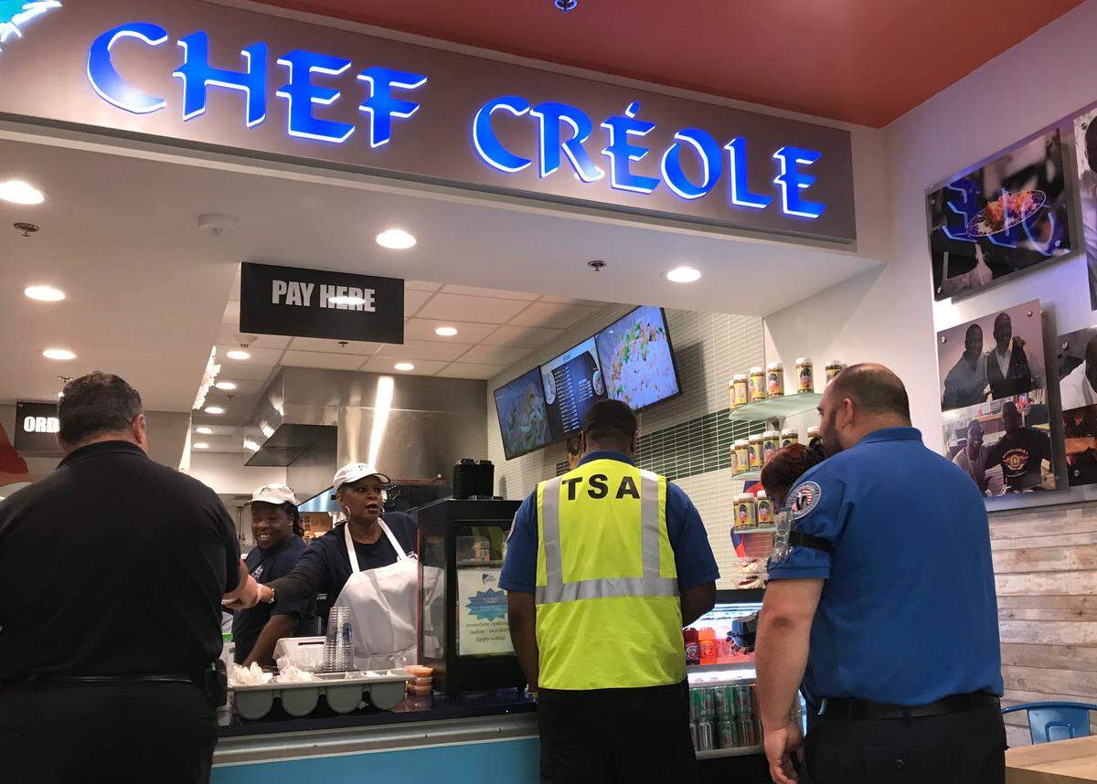 Federal employees working without pay at Miami International Airport visit the Chef Créole Haitian restaurant for a free dinner on Monday, Jan. 14, 2019. The locally owned restaurant began giving away free meals Monday, and served more than 300 in one day.