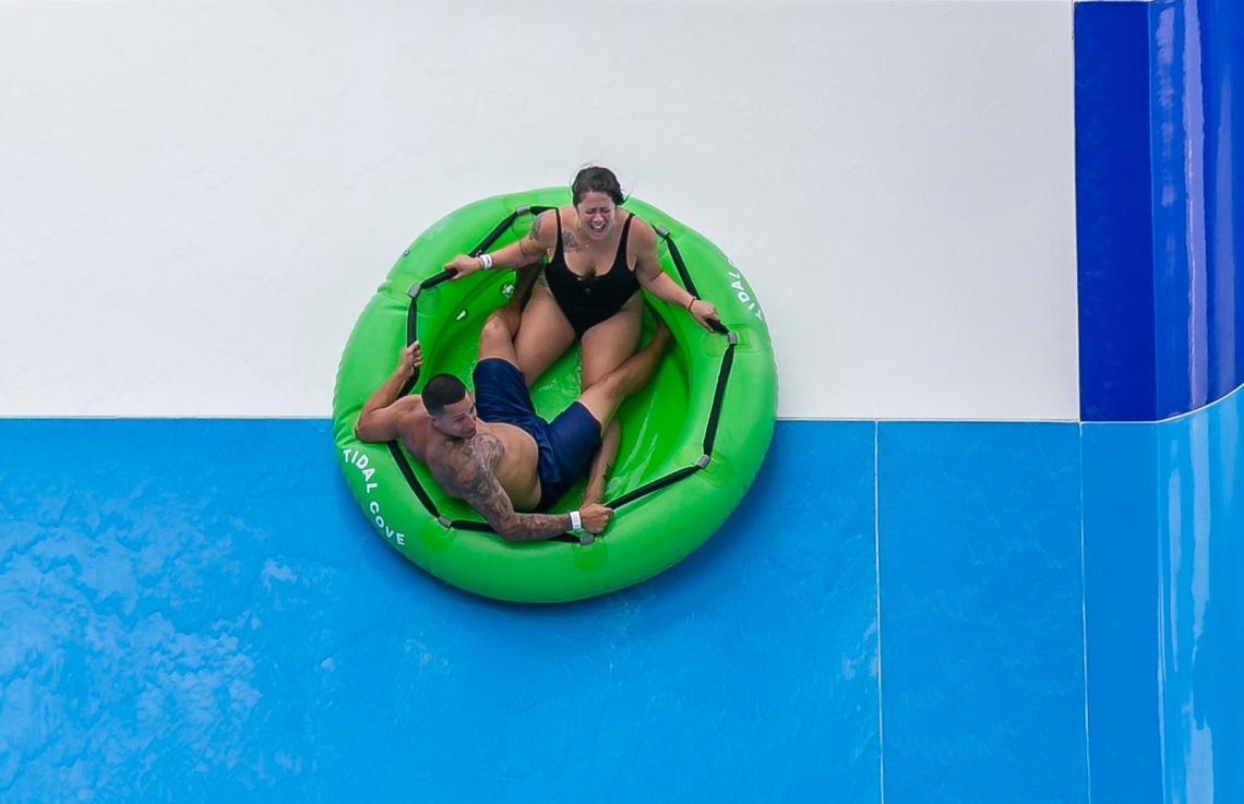 Andres Linares, 30, and his girlfriend, Angelica Gallego, 29, ride up and down the wall at one of the park’s water slides.