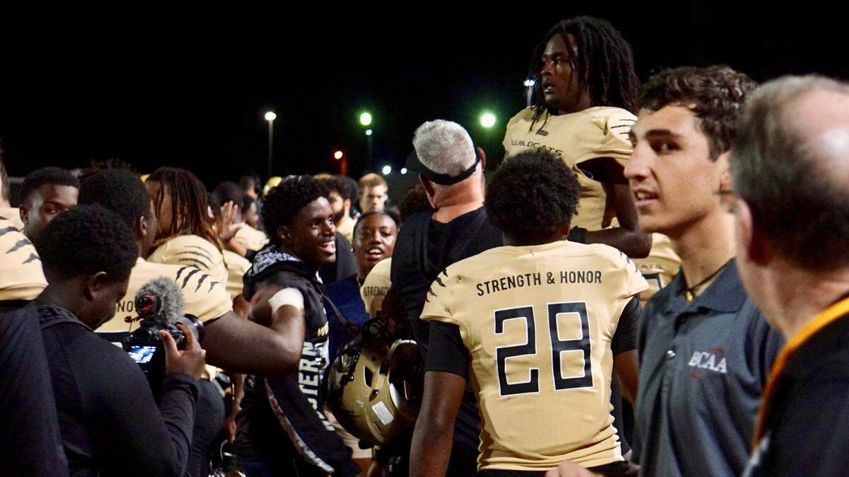 Western football coach Adam Ratkevich lifts up running back Miles Friday after Friday’s third-quarter touchdown in a Region 4-8A quarterfinal playoff game against South Dade on Friday, Nov. 8, 2019, at Western High School.