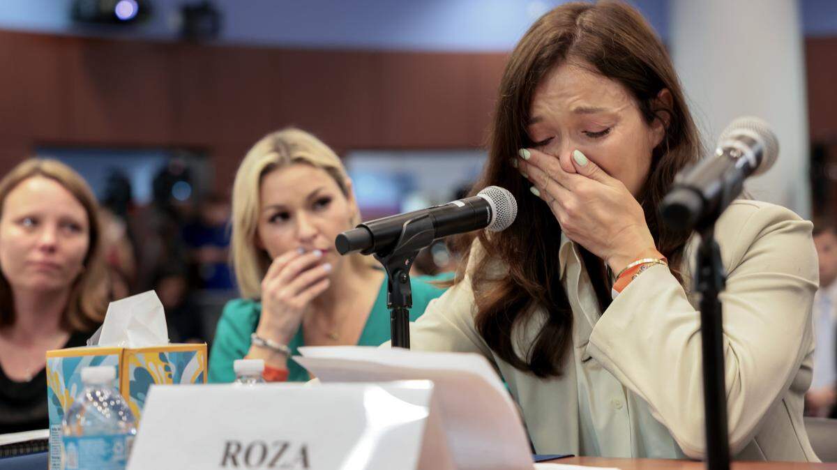 WEST PALM BEACH, FLORIDA - MAY 12: Victims of Jeffrey Epstein, (L-R) Jena-Lisa Jones, and Dani Hannah Bensky, listen as Roza testifies about her experience during a House Oversight Committee hearing with advocates and survivors of Jeffrey Epstein's sexual abuse case at West Palm Beach City Hall on May 12, 2026, in West Palm Beach, Florida. The hearing, organized by Democrats on the House Oversight Committee, focused on Epstein-related topics, including his plea deal years ago in Palm Beach County that people say allowed him to continue abusing young women. (Photo by Joe Raedle/Getty Images)