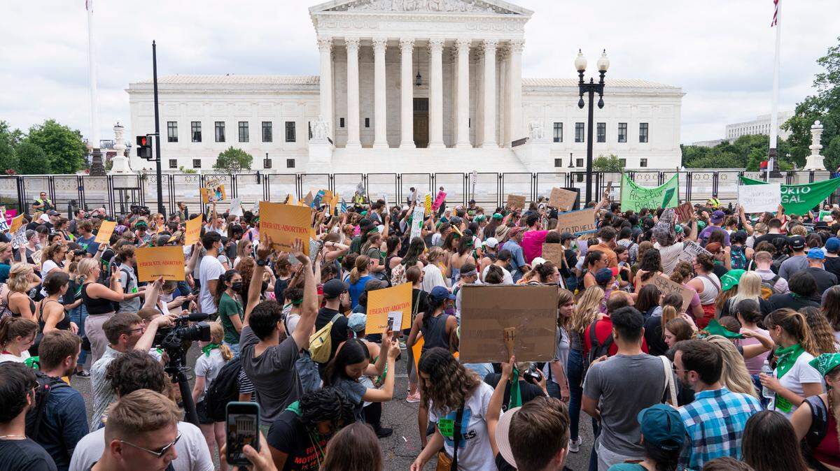 Protesters gather outside the Supreme Court in Washington on Friday, June 24, 2022, the day the Court ended constitutional protections for abortion that had been in place nearly 50 years.