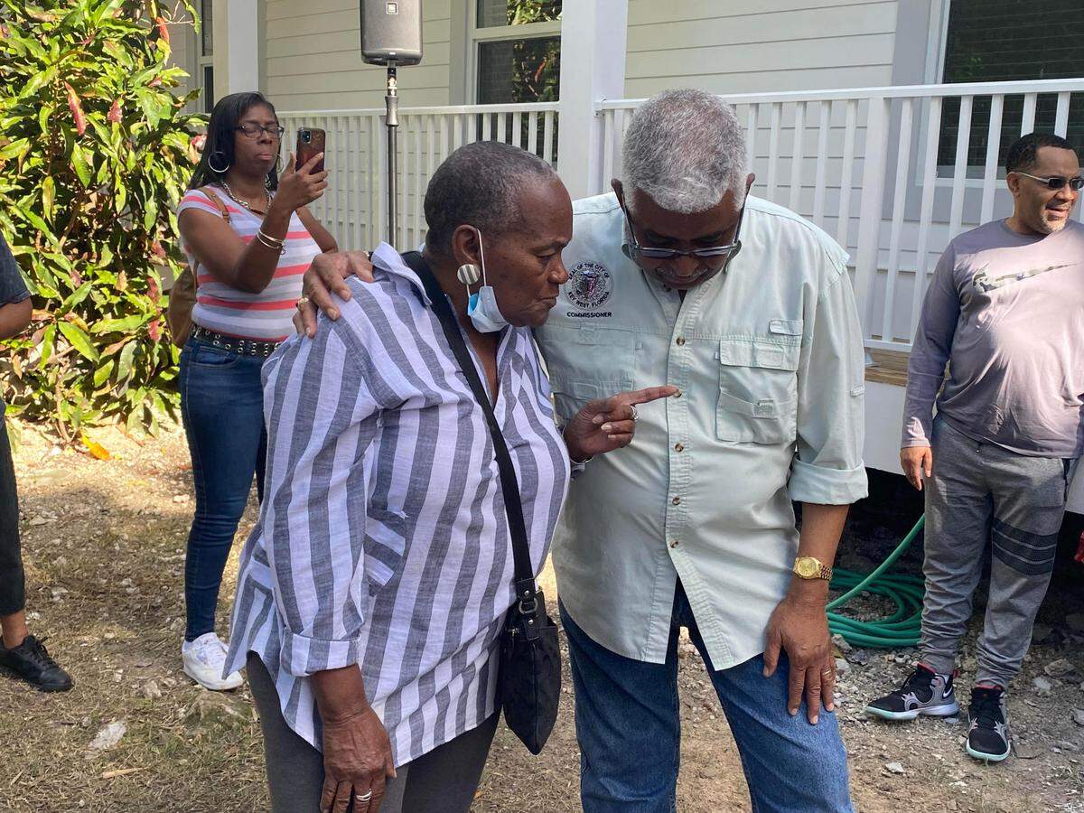 Alelia Butler speaks with Key West City Commissioner Clayton Lopez at the dedication ceremony of her new home on Dec. 22, 2021.