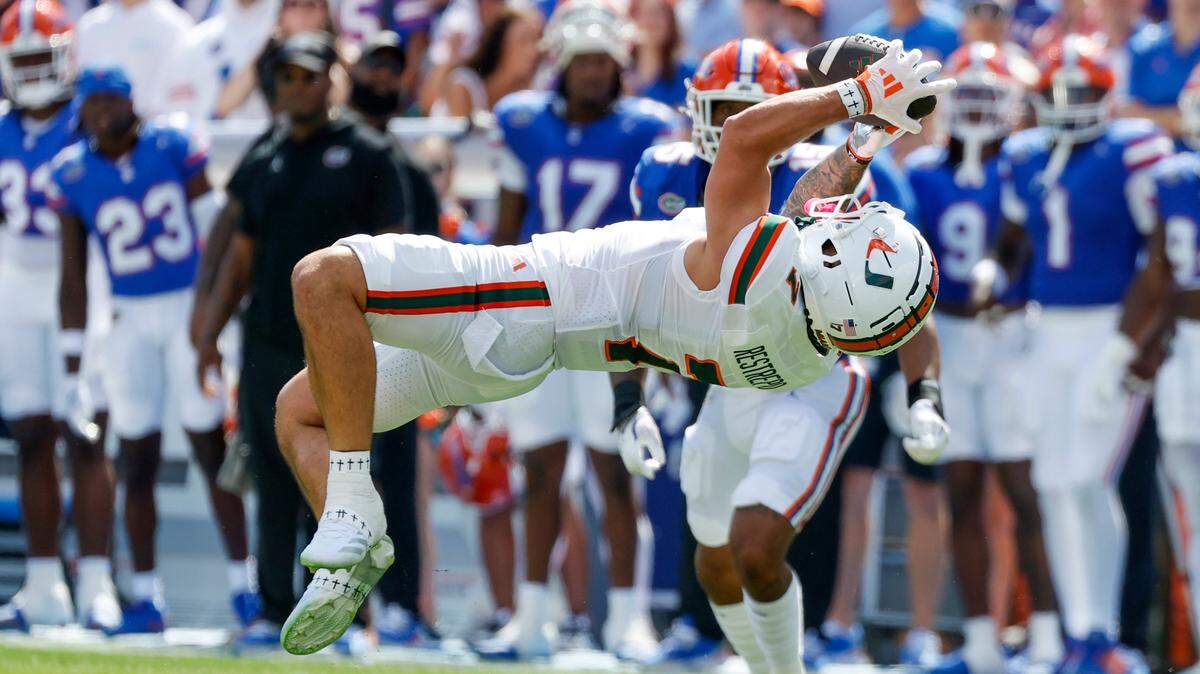 Miami Hurricanes wide receiver Xavier Restrepo (7) catches a pass during the first half of an NCAA college football game against the Florida Gators at Ben Hill Griffin Stadium in Gainesville, Florida, on Saturday, August 31, 2024.