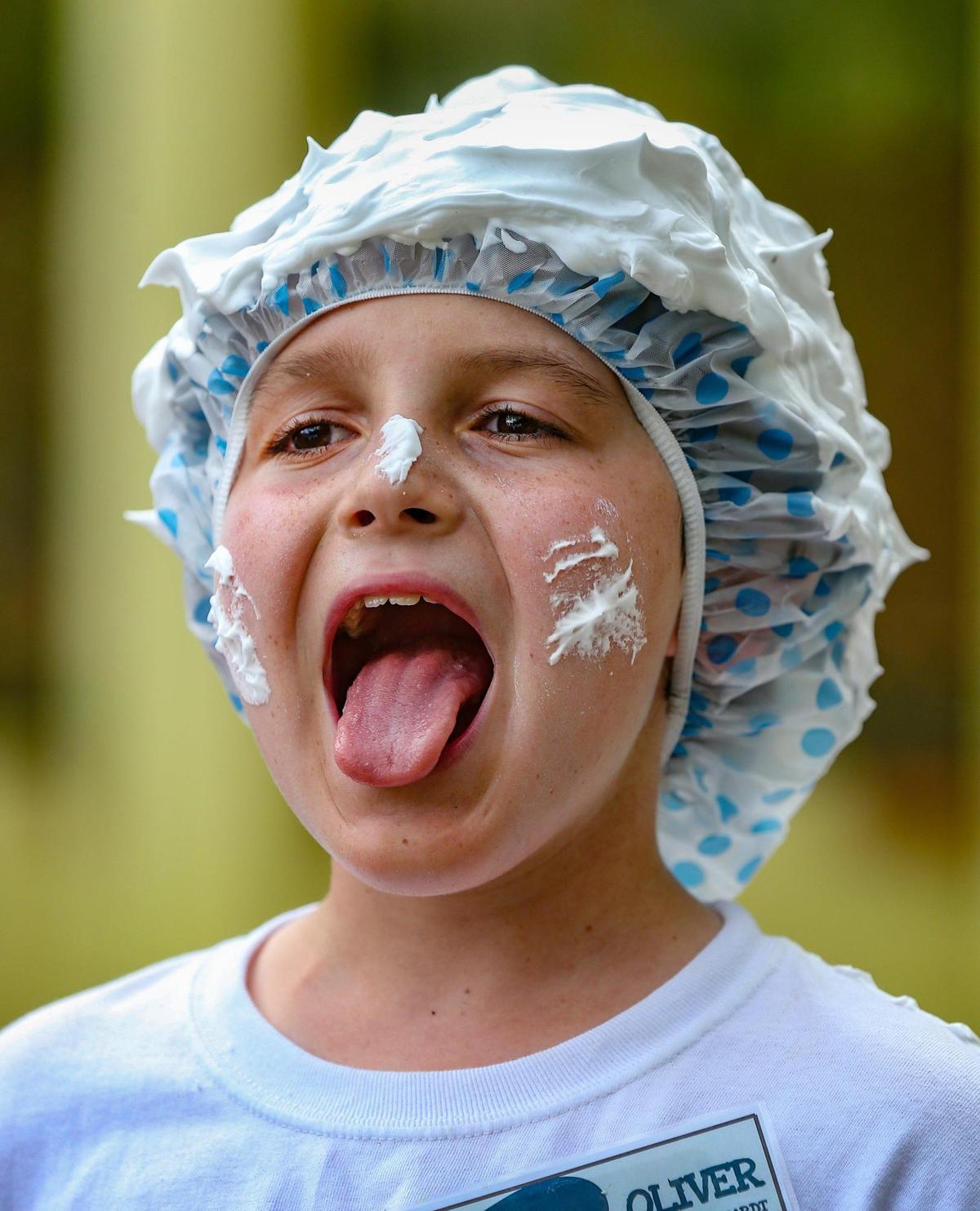 Lathered in shaving cream, Oliver reacts during a game at Camp U.O.T.S. on July 23.