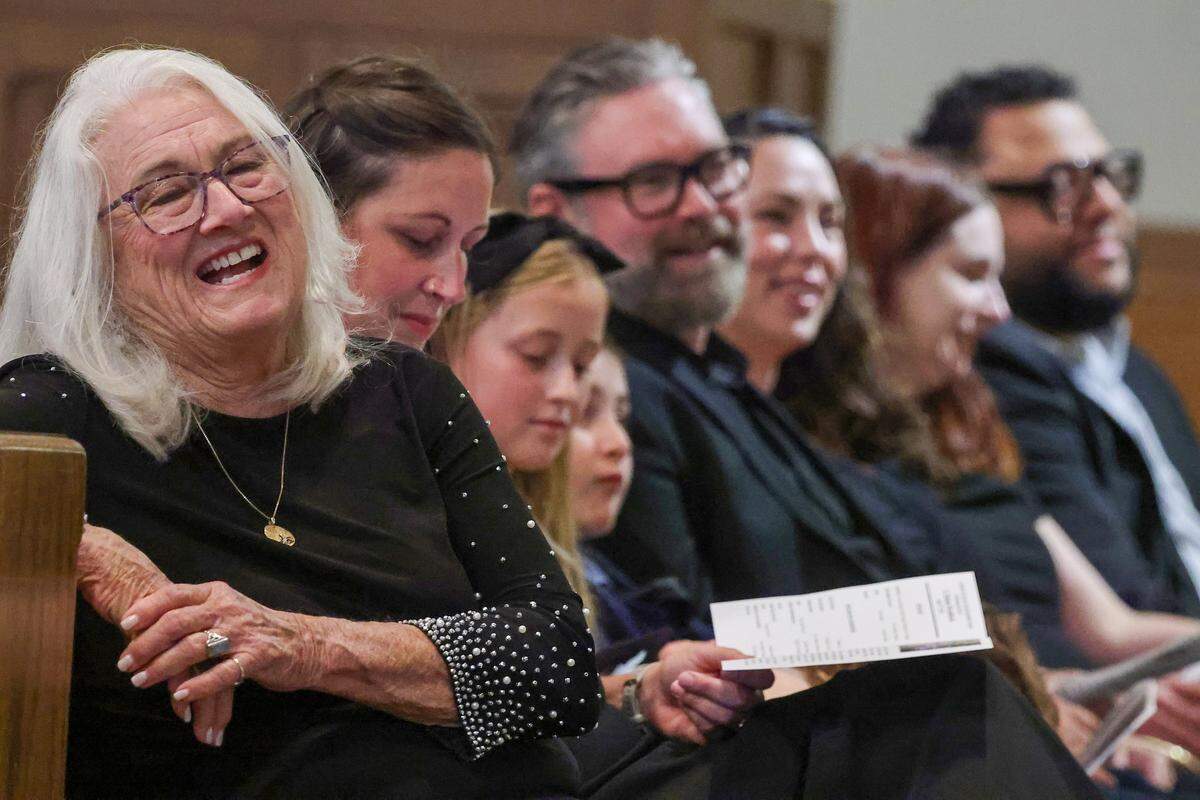 Sitting among relatives, Rebecca Nimmer, left, chuckles during her father's eulogy by Rev. Ruben Velasco. Former Miami-Dade School Board member Holmes Braddock, who passed away at 100, was honored at his celebration of life service on July 27, 2025, at Kendall United Methodist Church in Miami, Florida.