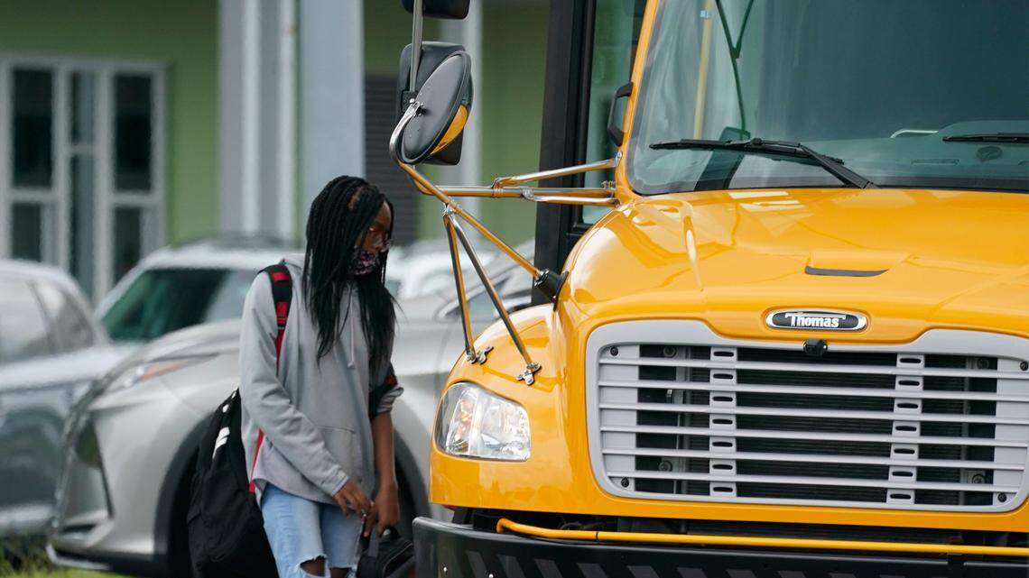 A student boards a school bus at Audubon Park Elementary School Monday, Aug. 16, 2021, in Orlando. Some of Florida’s largest school districts are finding it difficult to hire enough bus drivers as classes resume, with at least some of the shortage caused by the pandemic.