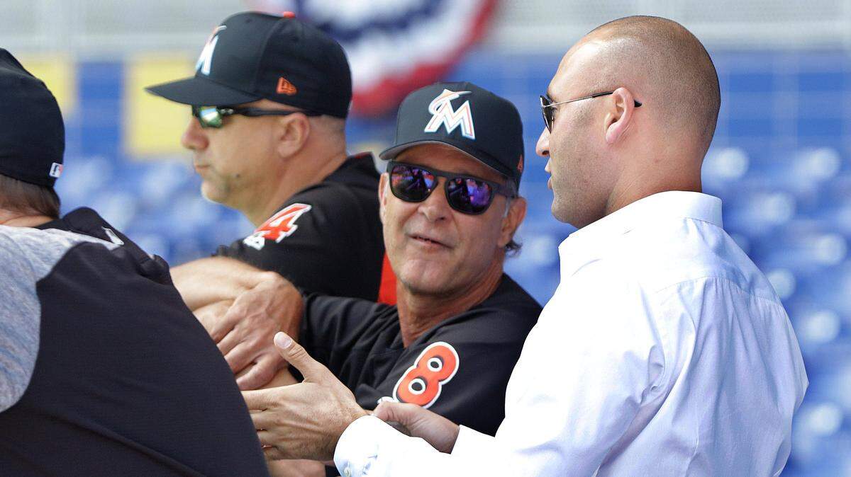 Miami Marlins CEO Derek Jeter (right), chats with Manager Don Mattingly, during a team stretch/workout a day before season opening’s work out day at Marlins Park on Wednesday, March 28, 2018.