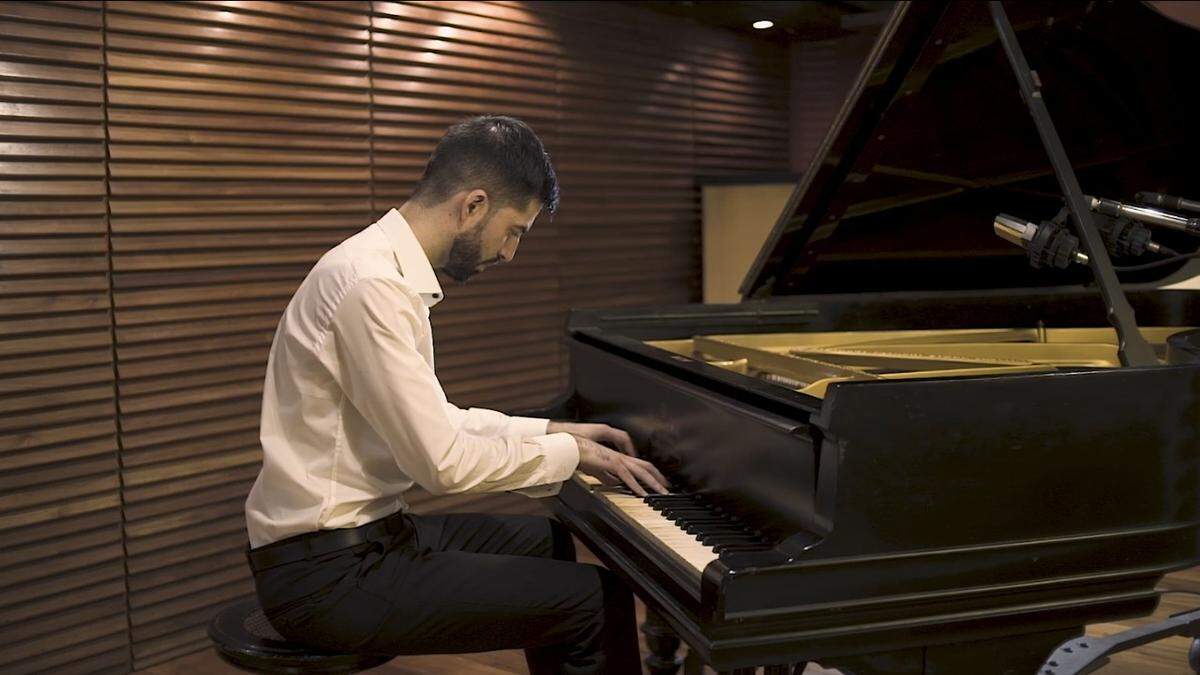 Former Royal Caribbean Group musical director Bruno Cruells plays piano in Buenos Aires, Argentina, in 2019.