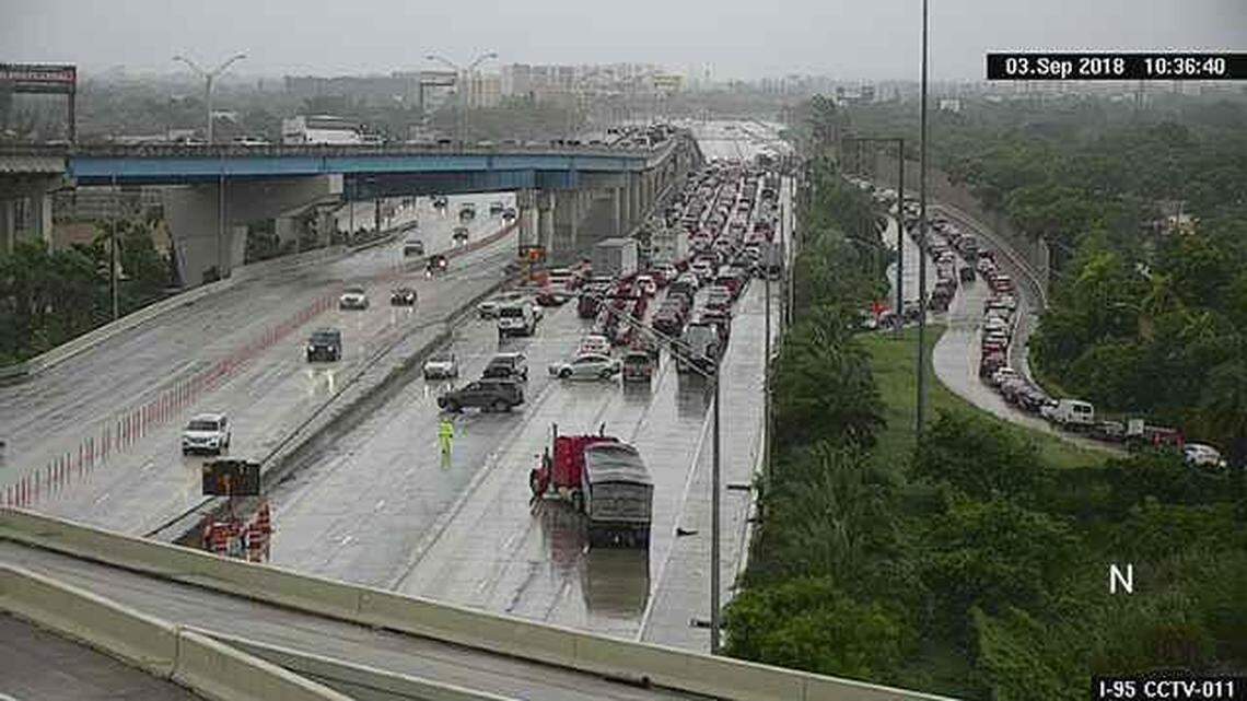 Cars at the back of the traffic jam turn around after a fatal crash shut down Interstate 95 northbound at State Road 112.