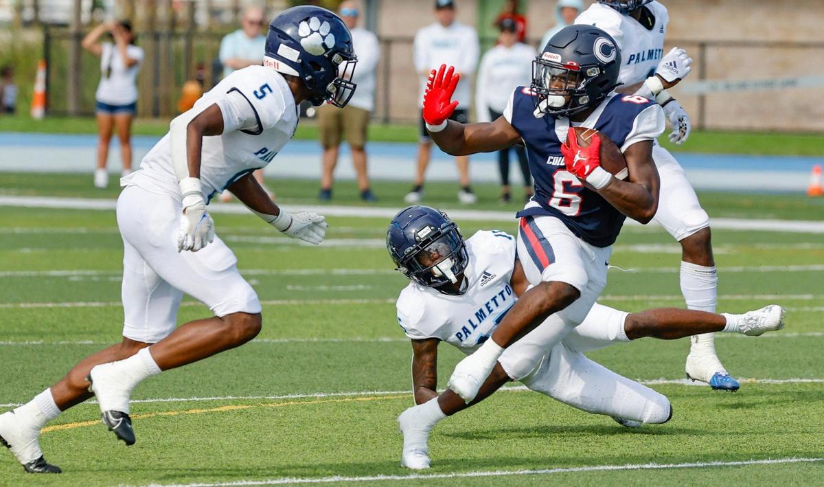 Columbus High School running back Edward Bandy (6) runs the ball as Palmetto High School cornerback Lawrence Johnson (5) defends in the first half at Tropical Park Stadium in Miami, Florida on Saturday, September 16, 2023.