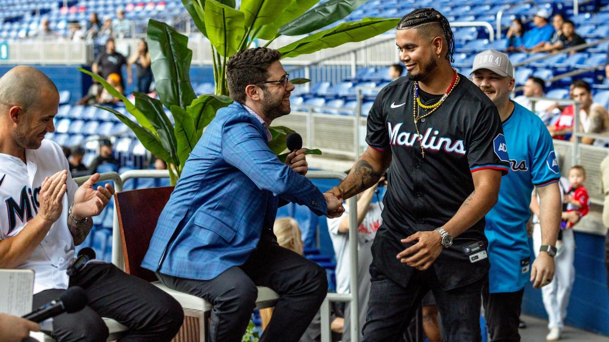 New Marlins General Manager Peter Bendix shakes hands with infielder Luis Arraez as he and Jake Burger introduce next season’s uniform during the Miami Marlins FanFest event at loanDepot park in Miami, Florida on Friday, January 26, 2024.