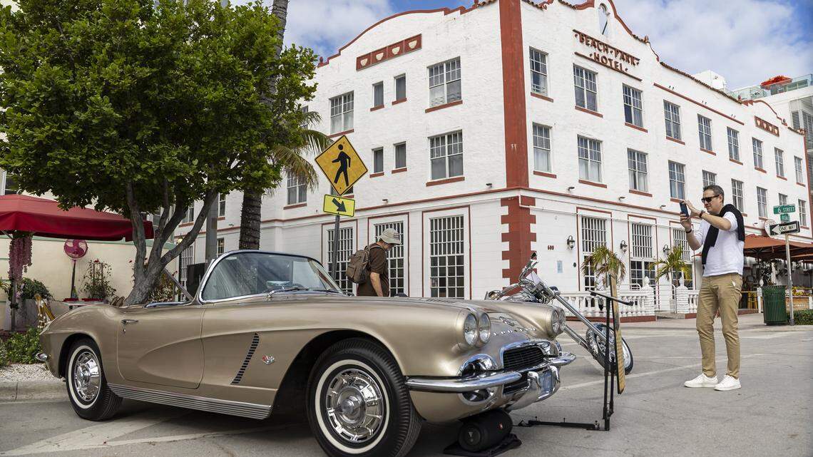 Matt Schulz, a tourist from Germany, takes a photo of a 1962 Corvette at the Classic Car Show during Art Deco Weekend on Ocean Drive on Saturday, Jan. 10, 2026, in Miami Beach, Fla.