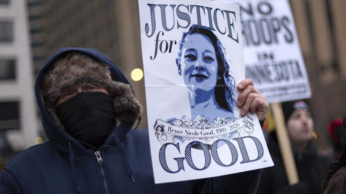 A demonstrator holds a sign with a photo of Renee Nicole Good, the 37-year-old woman fatally shot by an ICE agent, as he takes part in the nationwide "Stop ICE Terror" rally in Minneapolis, Minnesota, on Jan. 20, 2026, in protest against President Donald Trump's policies.
