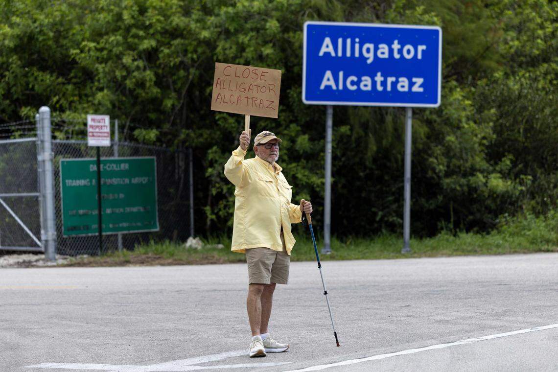 Naples resident Bill Hamilton, 73, holds a sign that reads “CLOSE ALLIGATOR ALCATRAZ” after an interfaith vigil outside the migrant detention center in the Everglades.