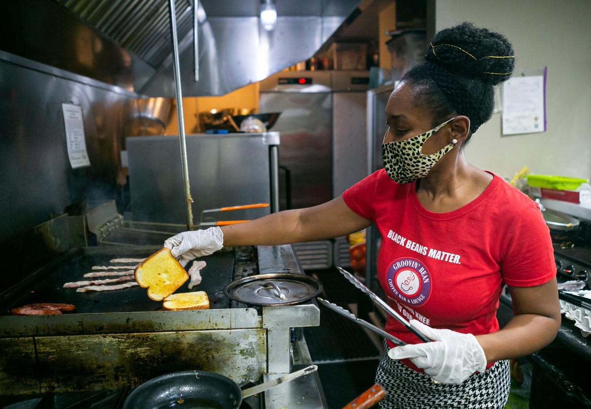 Monique Messer, 36, co-owner of Groovin’ Bean Coffee Bar & Lounge works in her kitchen.