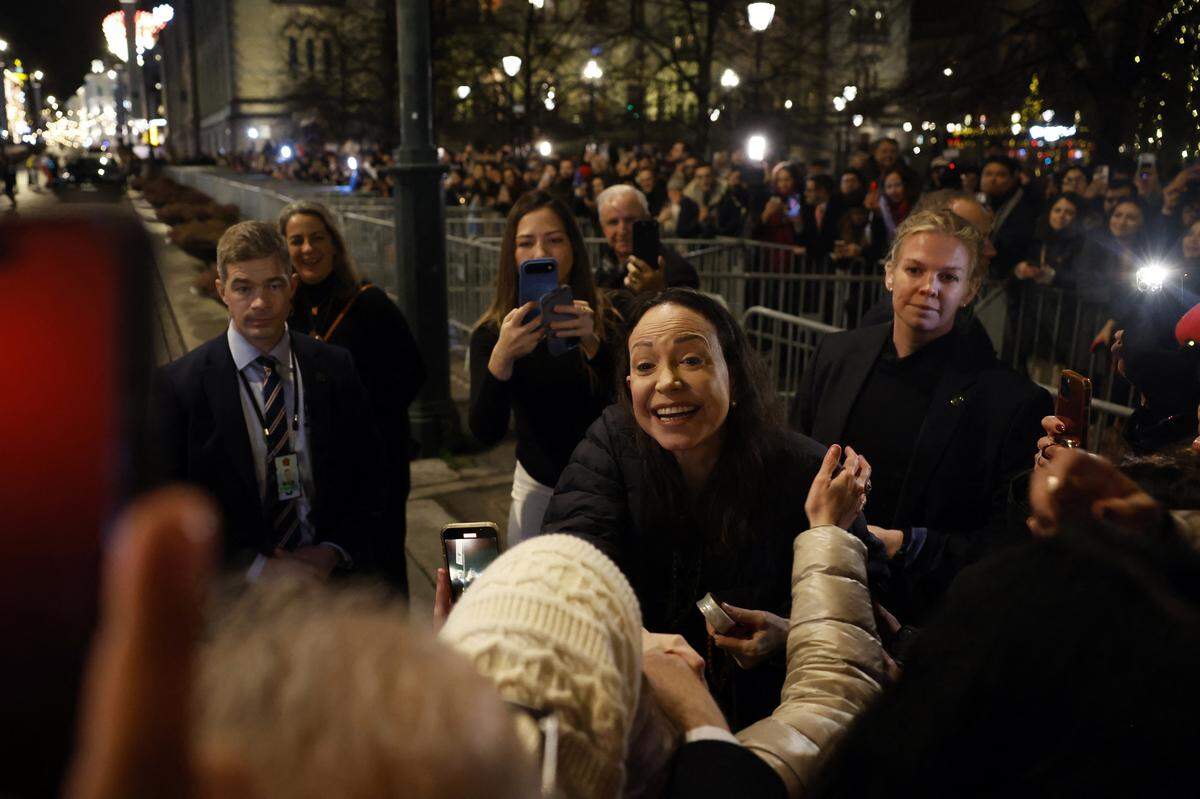 Nobel Peace Prize laureate Maria Corina Machado greets supporters gathered outside the Grand Hotel in Oslo, Norway, in the early hours of Dec. 11, 2025. 