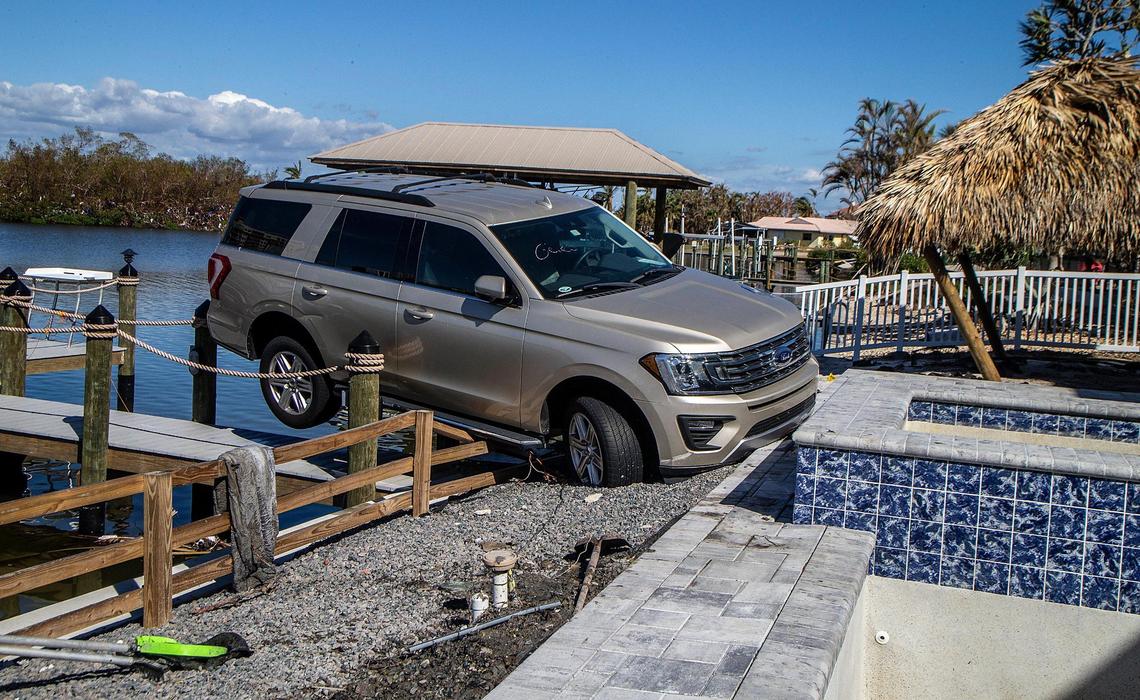 A Ford Expedition SUV rests on a seawall behind a house on Lagoon Road in Fort Myers Beach Wednesday, Oct. 26, 2022. It was one of hundreds of cars displaced during Hurricane Ian, which made landfall in the area Wednesday, Sept. 28, 2022.