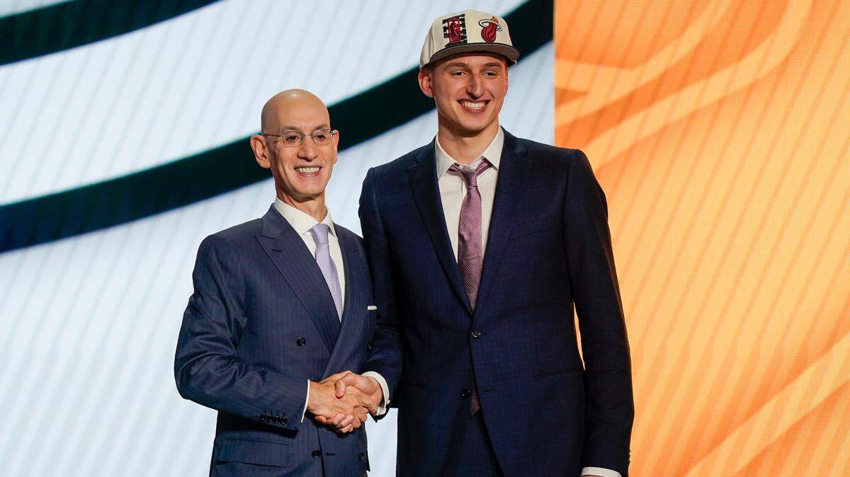 Nikola Jovic shakes hands with NBA Commissioner Adam Silver after being selected 27th overall by the Miami Heat in the NBA basketball draft, Thursday, June 23, 2022, in New York.