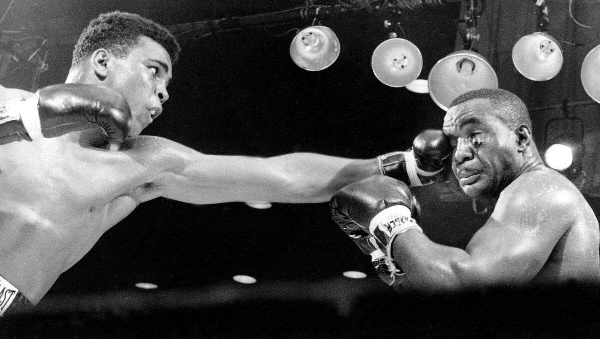 Cassius Clay, left, connects on a punch to the face of Sonny Liston in the third round before a TKO in the seventh round of their heavyweight championship fight in Miami Beach, Fla., on Feb. 25, 1964.