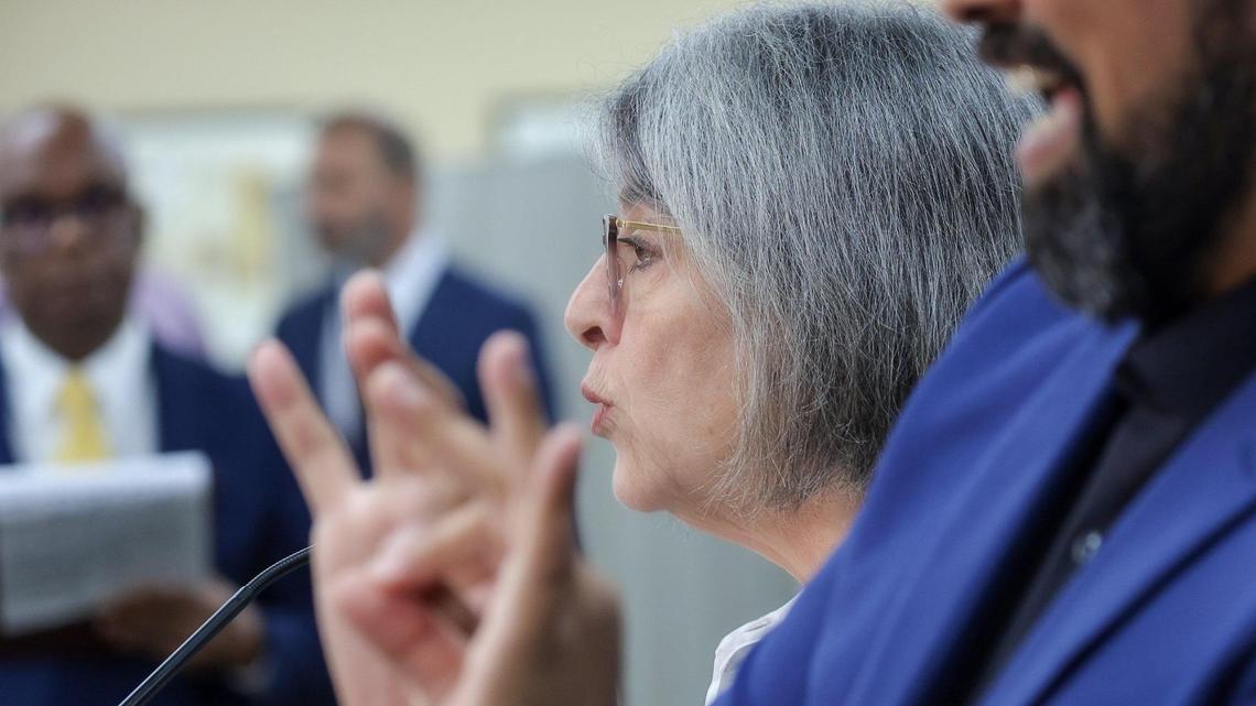 Mayor Daniella Levine Cava, left, unveils her 2026 budget proposal, which includes spending cuts to close a projected deficit of more than $400 million, as interpreter Alexander Fernandez, right, signs for the hearing impaired on Tuesday, July 15, 2025, in Miami, Florida.