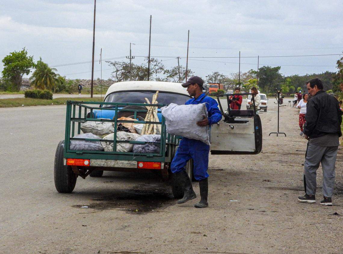 A man buys charcoal on a road in Havana on February 6, 2026. Across Cuba, families are scrambling to cope with relentless blackouts and shortages worsening under economic pressure from President Donald Trump. 