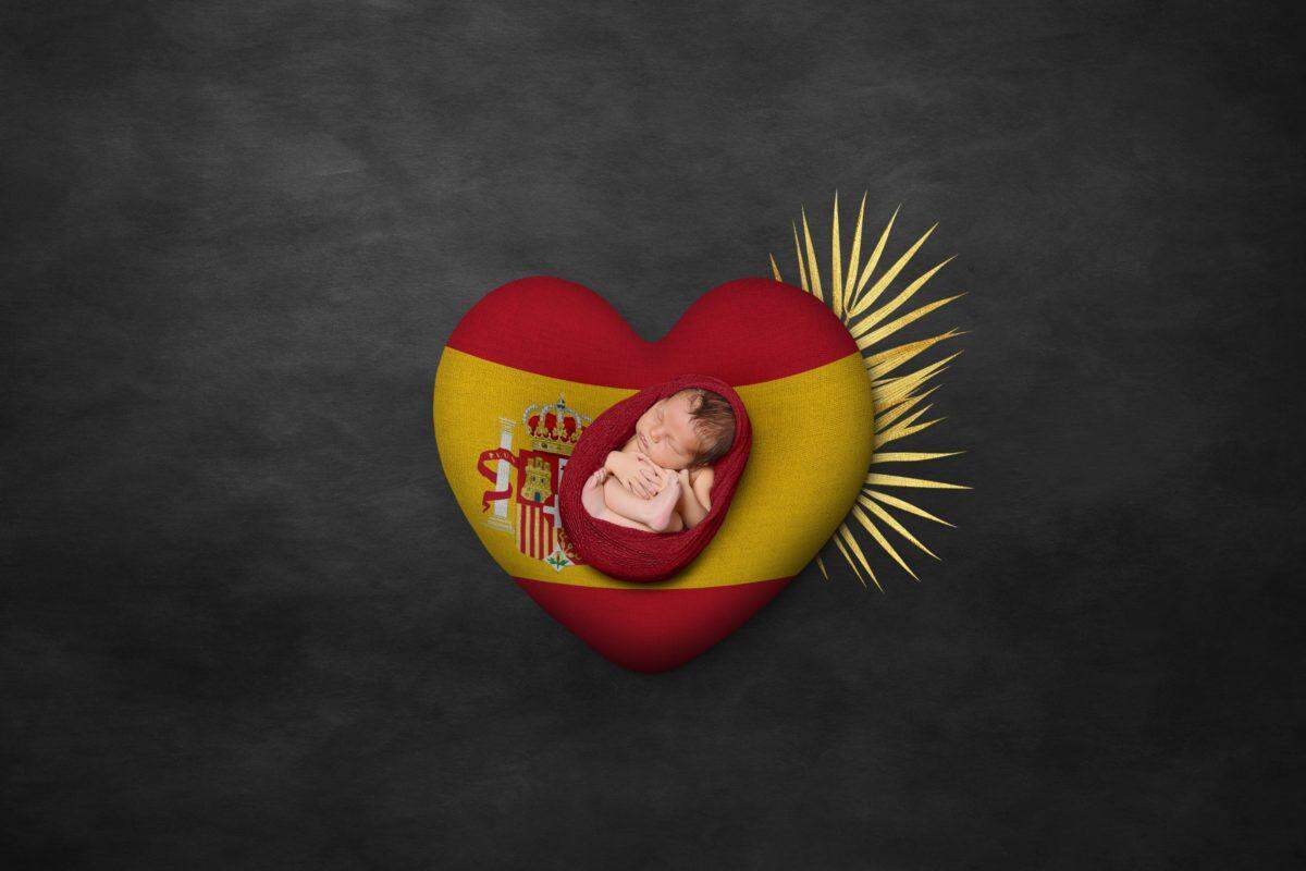 newborn baby wrapped in spain flag