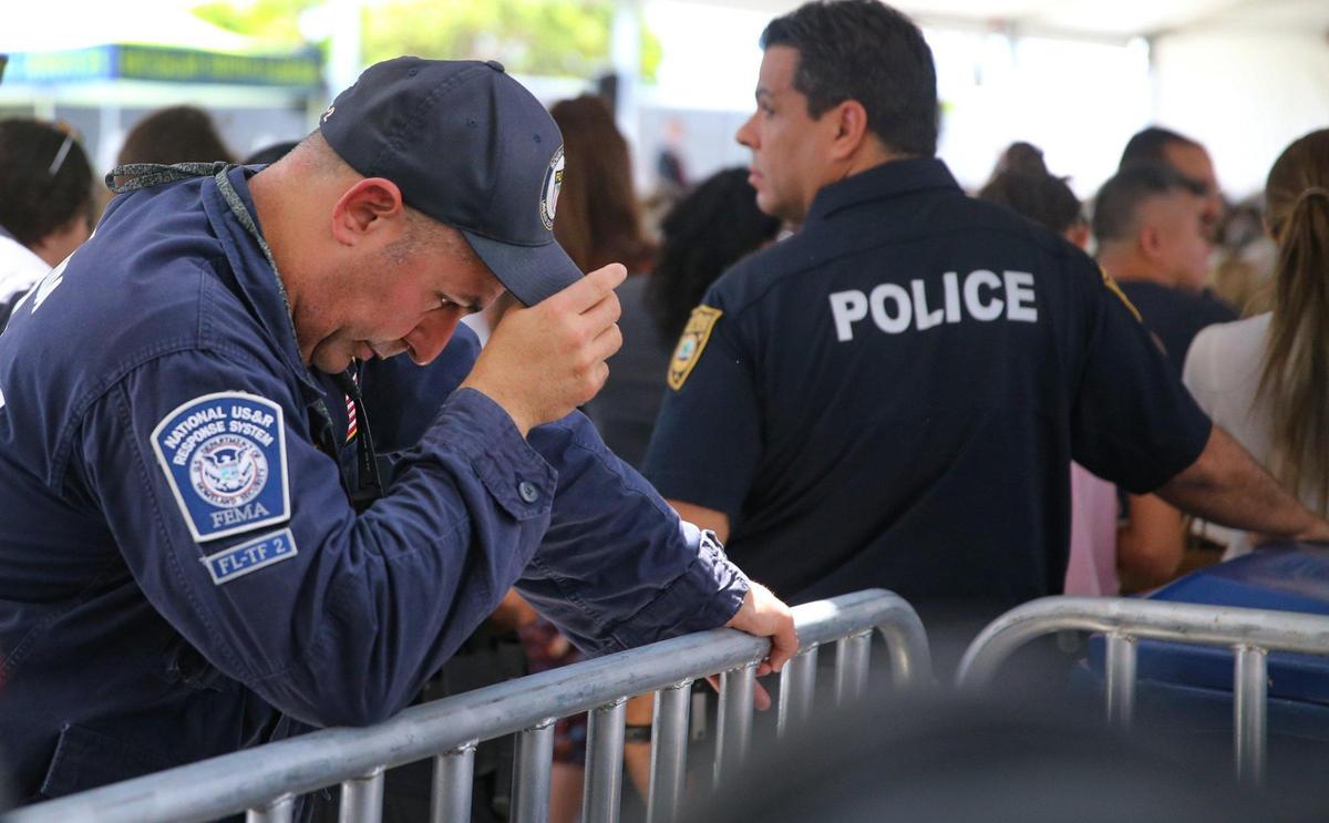 FEMA Urban Search and Rescue worker O. Gomez takes time to reflect during a public memorial event on Friday, June 24, 2022, to mark the one-year anniversary of the collapse of Champlain Towers South in Surfside, Florida.