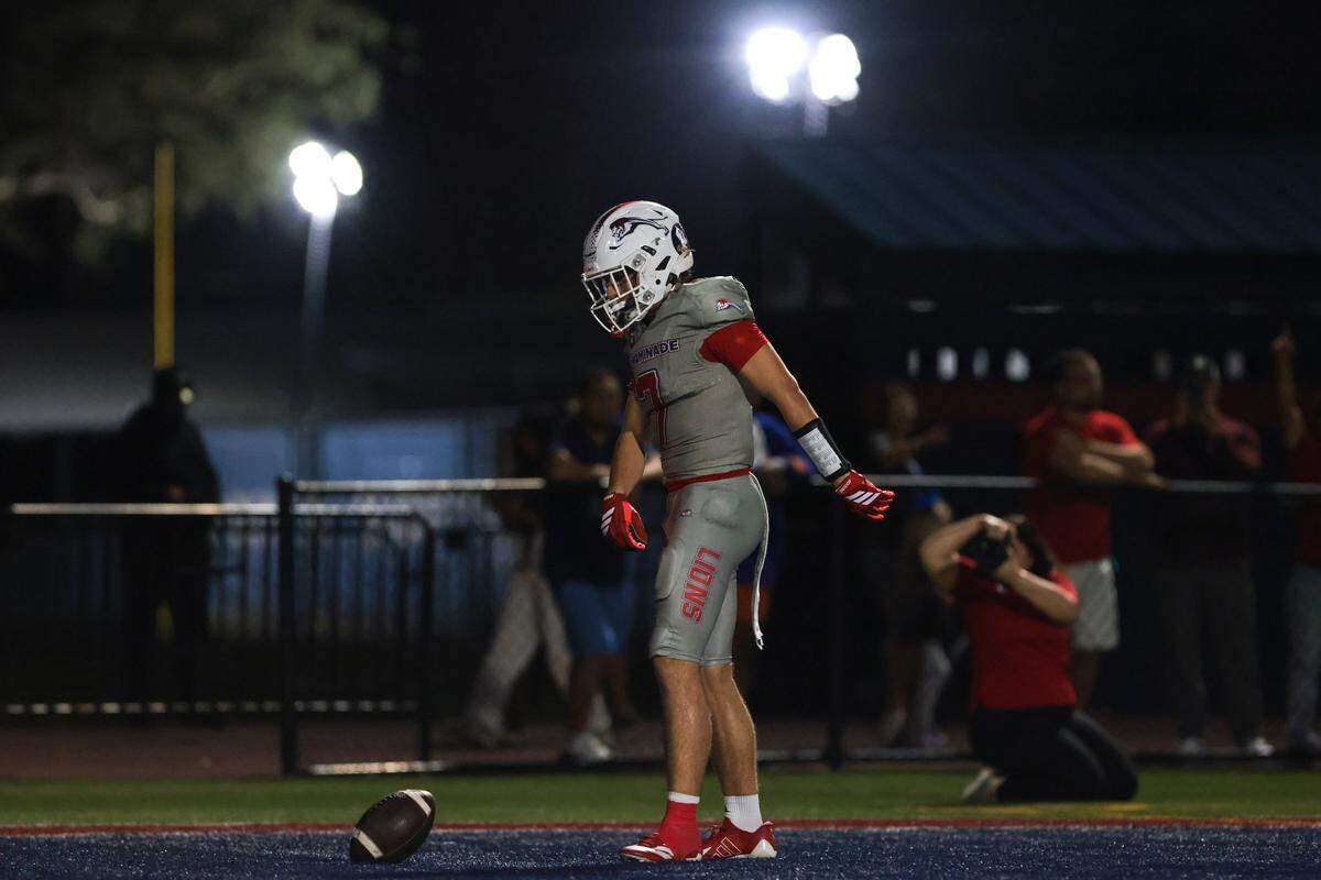 Chaminade-Madonna Lions wide receiver Jasen Lopez (7) celebrates after scoring a touchdown against Trinity Christian Academy during the first half of a Class 1A football state semifinal game at Chaminade-Madonna College Preparatory on Friday, Dec. 5, 2025 in Hollywood, Fla.