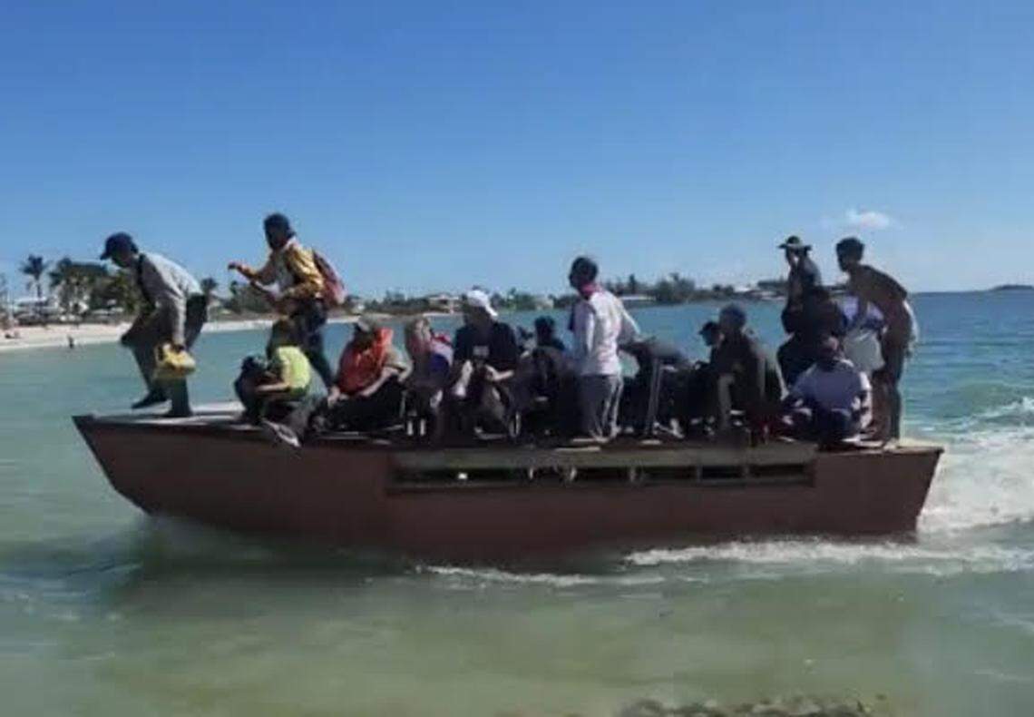 A group of about 20 people jump off a Cuban migrant boat as it arrives on Sombrero Beach in the Middle Florida Keys city of Marathon Monday, Nov. 14, 2022.