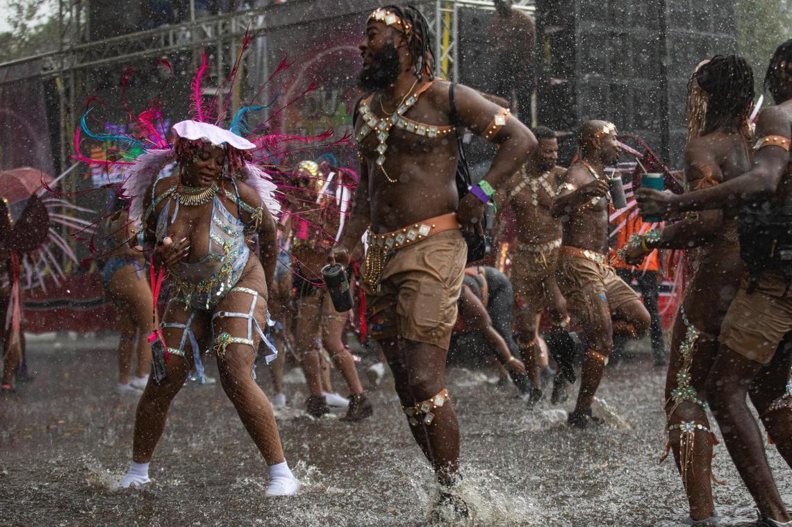 Performers dance in the rain during Miami Carnival at the Miami-Dade County Fair Expo in Miami, Florida on Sunday, October 9, 2022.