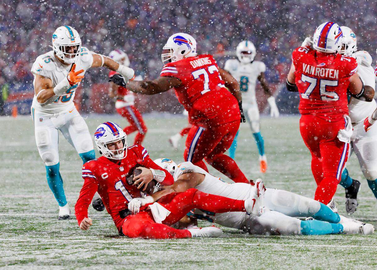 Buffalo Bills quarterback Josh Allen (17) is being sacked by Miami Dolphins defensive tackle Zach Sieler (92) during fourth quarter of an NFL football game at Highmark Stadium on Saturday, December 17, 2022 in Orchard Park, New York.