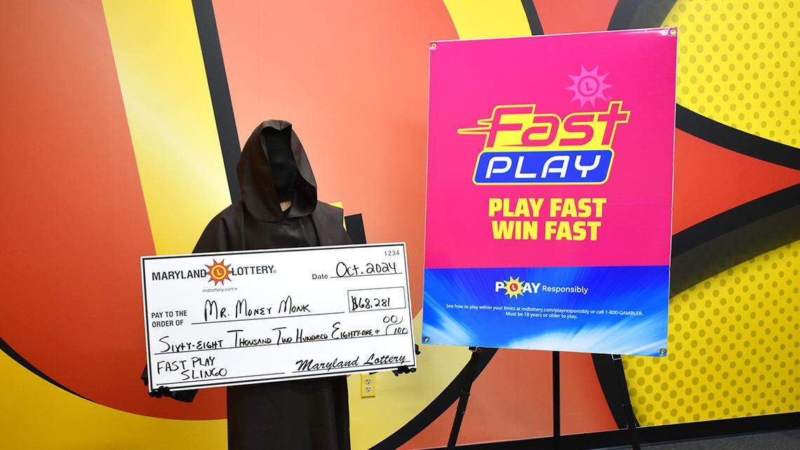 Mr. Money Monk wore a black costume monk’s robe for his photo, telling lottery officials it represents his “monk-like focus.”