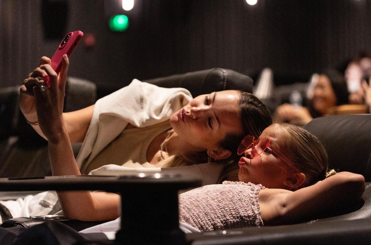 Sisters Lauren, 31, and Celine “Cece” Del Valle, 7, take a photo while they wait for the Barbie movie to start at Cinépolis Coconut Grove in Miami, Fla., on Sunday, July 23, 2023. Lauren took Cece and her sister Coco, 9, (not pictured) to see the movie.