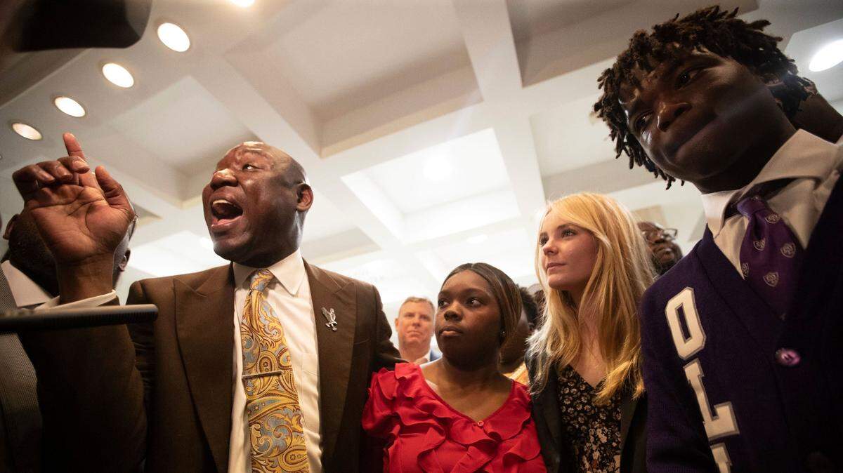 Attorney Ben Crump, left, stands with the three Leon County high school students who are threatening to file a lawsuit against Florida Gov. Ron DeSantis and his administration if they ban a proposed Advanced Placement course on African American Studies in Florida schools, Wednesday, Jan. 25, 2023, in the Capitol in Tallahassee, Fla.