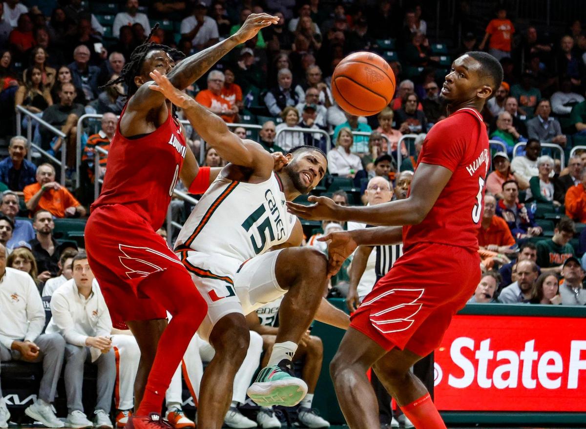 Miami Hurricanes forward Norchad Omier (15) battles for a rebound with Louisville Cardinals guard Mike James (0) and forward Brandon Huntley-Hatfield (5) in the second half at the Watsco Center in Coral Gables, Florida, on Wednesday, January 10, 2024.