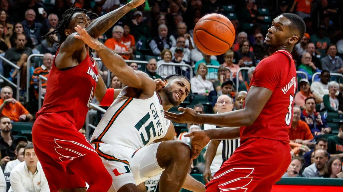 Miami Hurricanes forward Norchad Omier (15) battles for a rebound with Louisville Cardinals guard Mike James (0) and forward Brandon Huntley-Hatfield (5) in the second half at the Watsco Center in Coral Gables, Florida, on Wednesday, January 10, 2024.