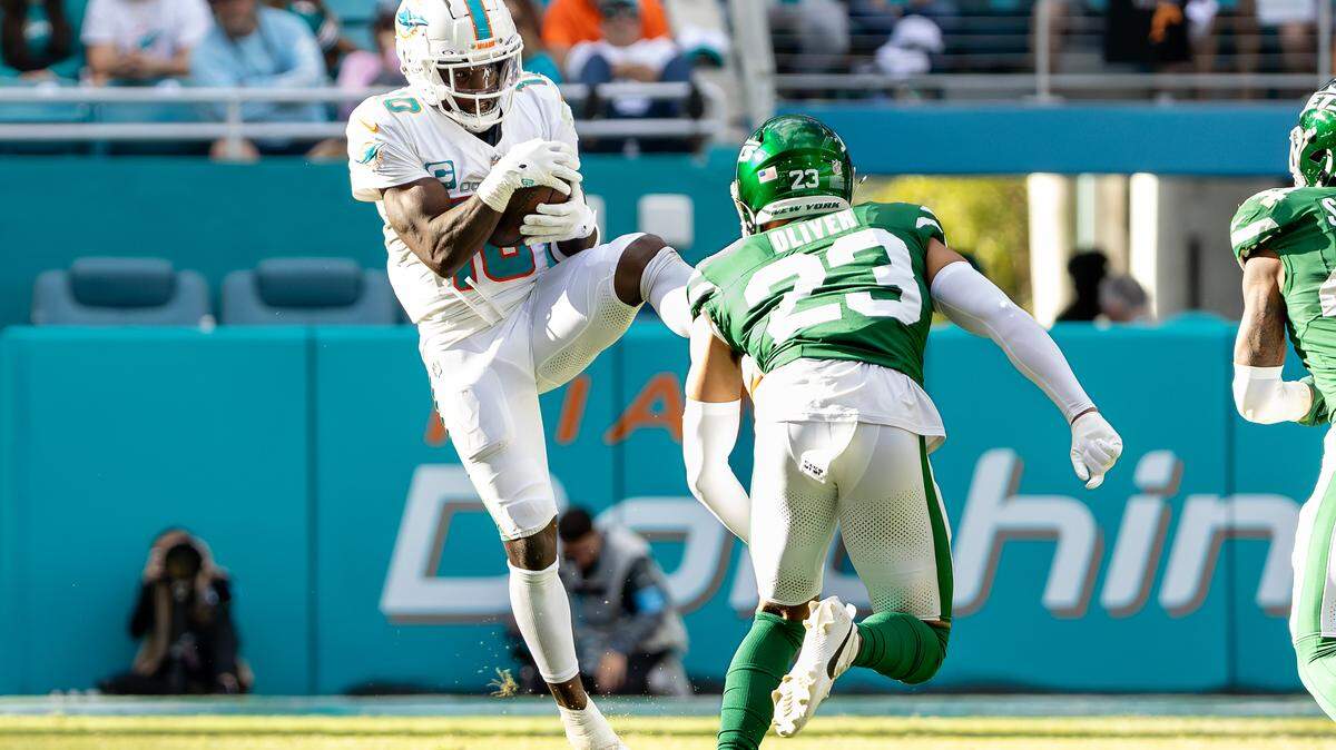 Miami Dolphins wide receiver Tyreek Hill (10) catches a pass while defended by New York Jets cornerback Isaiah Oliver (23) during the second half of their NFL game at Hard Rock Stadium on Sunday, Dec. 8, 2024, in Miami Gardens, Florida.